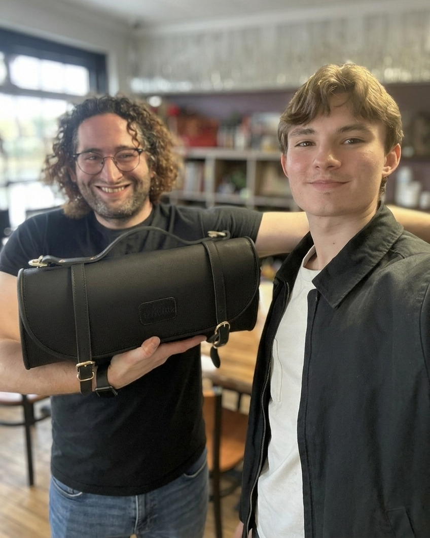 Two men, Jason and Glenn, founder and artisan holding a knife roll